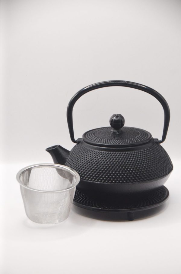 cast iron teapot with basket